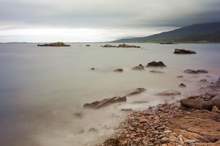 stones and boulders in milky sea long exposure rocky beach at Dingle peninsula Irelandの写真素材