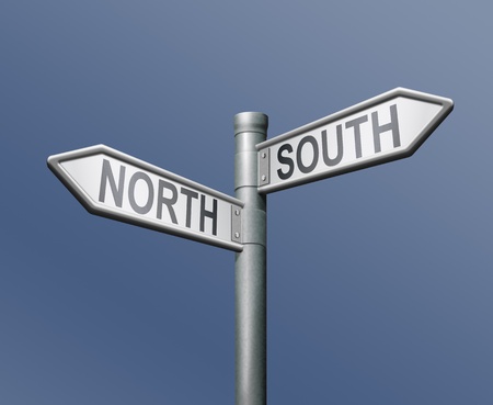 north south road sign on blue backgroundの写真素材