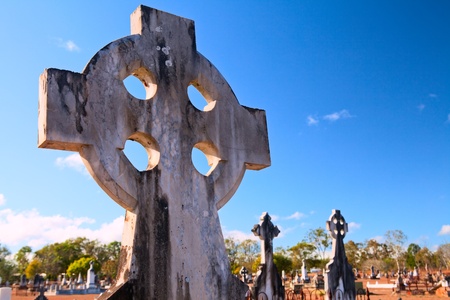 celtic cross on australian graveyard old ancient burial ground cemetery tombstone with copy space in blue skyの写真素材