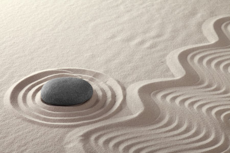 rock garden zen buddhism meditation stone and lines in sand Japanese culture concept for balance...