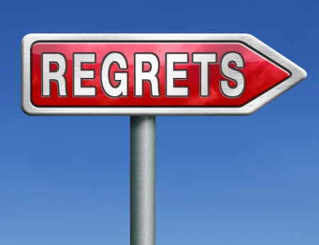 regret or no regrets saying sorry and offer apologize being ashamed for bad decisions red road sign arrow with text word conceptの写真素材