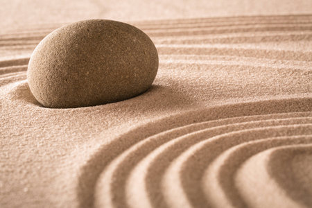 spirituality stone and lines in sand, Japanese garden for balance harmony purity and spiritual guidance rock backgroundの写真素材