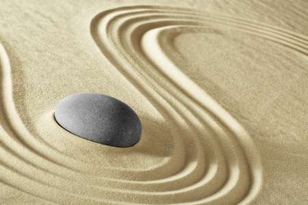 Spa wellnees background massage stone treatment and therapy. Purity serenity harmony and balance in round rock and lines in the sand.の写真素材