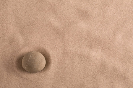 zen stone minimal background for yoga, meditation or relaxation. Meditation rock in sand with copy...