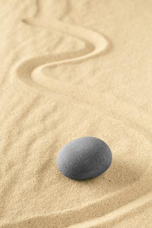 Healing treatment or spiritual therapy trough relaxation and meditation concentrating on a zen stone garden. Spa wellness background with sand texture.の写真素材