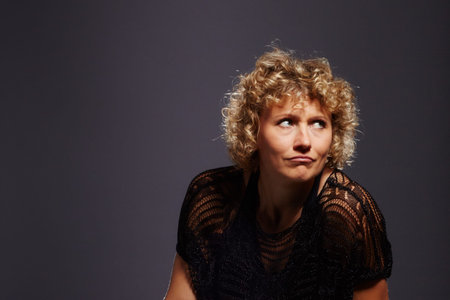 Blonde curly woman looksの写真素材