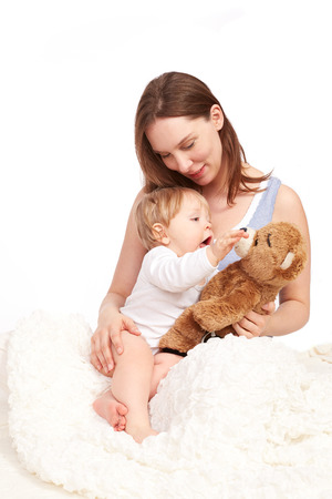 Mother and child playing with teddyの写真素材