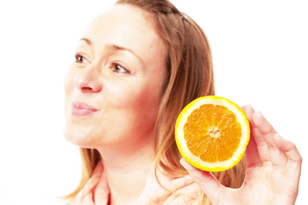 Young pretty woman with orangeの写真素材
