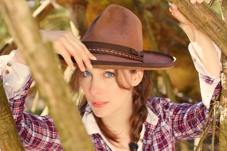 women with cowboy hat in the fieldの写真素材