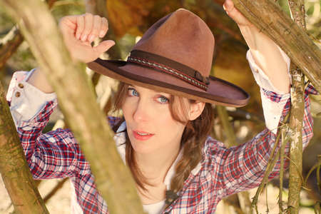 women with cowboy hat in the fieldの写真素材
