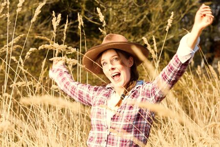 women with cowboy hat in the fieldの写真素材