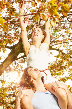 Young couple romantic blossom under the cherry treeの写真素材