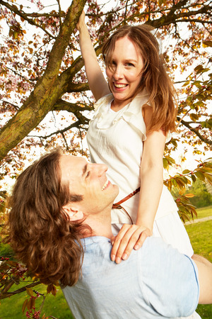 Young couple romantic blossom under the cherry treeの写真素材