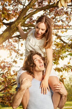 Young couple romantic blossom under the cherry treeの写真素材