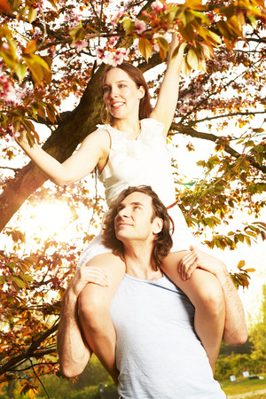 Young couple romantic blossom under the cherry treeの写真素材