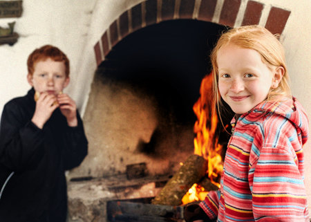 Boy and girl together by the fireside..の写真素材