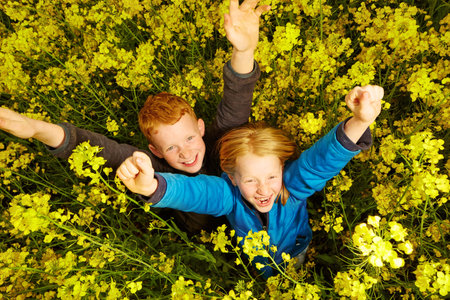 Boy and girl in rape field..の写真素材