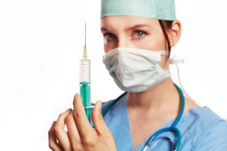 Nurse in blue dress with Op stethoscope and syringe as Cut .の写真素材