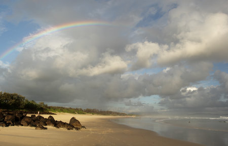 Rainbow in early morning at the beach of Byron Bay, Australia.の写真素材