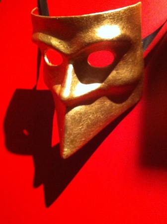 Bauta mask gold plated on red backgroundの素材
