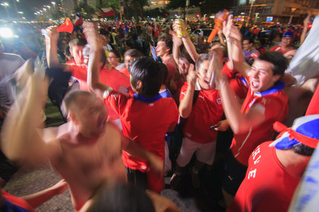 RIO DE JANEIRO - JUNE 18: A crowd of Chilean Fans celebrate Chile's victory over Spain.のeditorial素材