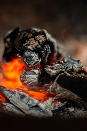 Decaying coals for cooking and a backgroundの写真素材