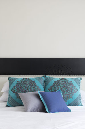 White Bed with White and Blue decorated Pillows