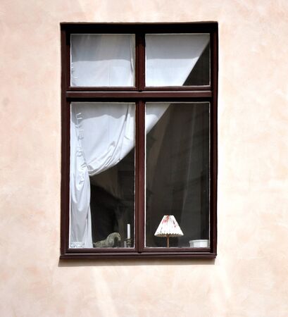 The window in the house, brown frame with a white curtain.のeditorial素材