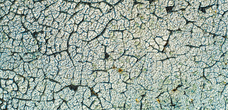 Old paint white. Cracked metal sheet.