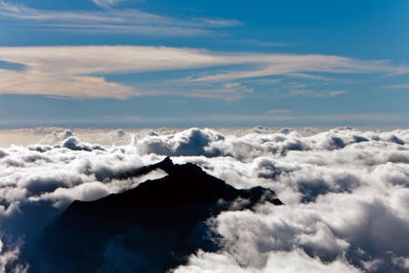 view of the clouds with the peak of Mountの写真素材