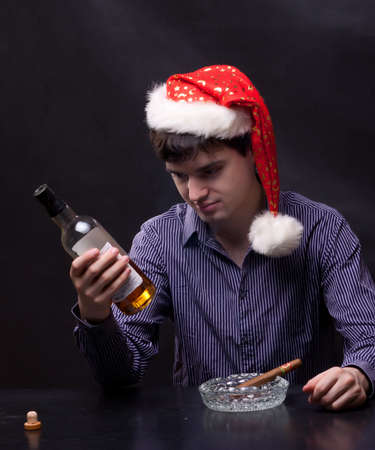 photo of man drinks alcohol and smokes a cigarの写真素材
