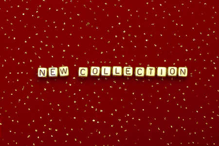 photo of words "new collection" of beads on a red velvet with sequinsの写真素材