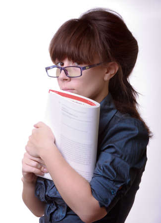 Portrait of young alluring brunette woman, holding book on white backgroundの写真素材