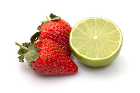 Strawberries with lime closeup over white backgroundの写真素材