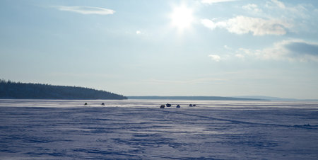 sun above frozen lake in winterの写真素材
