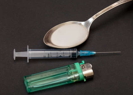 Syringe, spoon, heroin and lighter, concept of addictionの写真素材