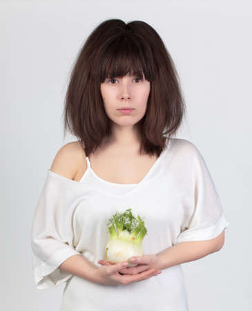 The young beautiful woman with the fresh vegetables, the concept of healthy foodの写真素材