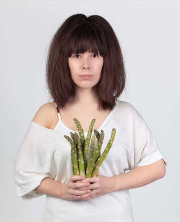 The young beautiful woman with the fresh vegetables, the concept of healthy foodの写真素材