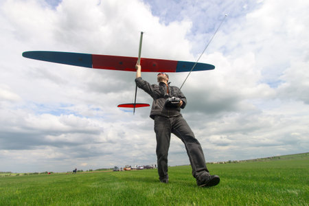 Man launches into the sky RC glider, wide-angle