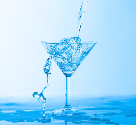 Water Splashing in a Wineglass, on blue background