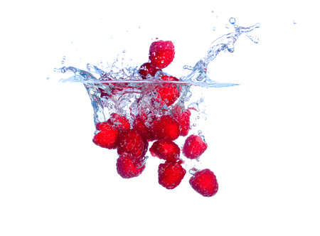 Red Raspberries Falls under Water with a Splash, isolatedの写真素材