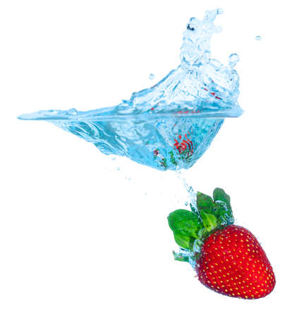 Fresh Strawberry Dropped into Water with Splash on white backgroundsの写真素材