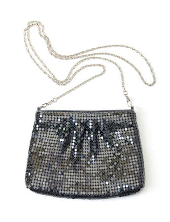 Classic black handbag with a silver chain strap on a white studio backgroundの写真素材