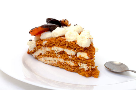 Piece of sweet cake on plate, closeup, white backgroundの写真素材