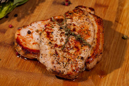 Grilled steak on wooden cutting boardの写真素材