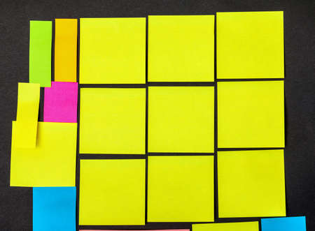 Set of multicolored paper sticky stickers, on black boardの写真素材