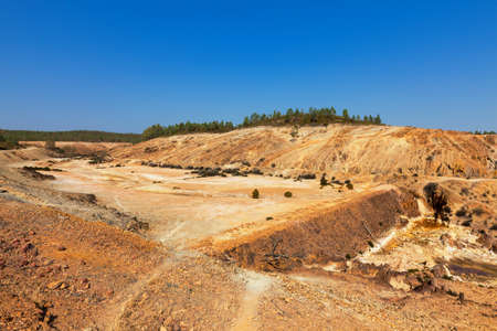 Earth dam wall with an empty dam in a dry dusty landscapeの写真素材