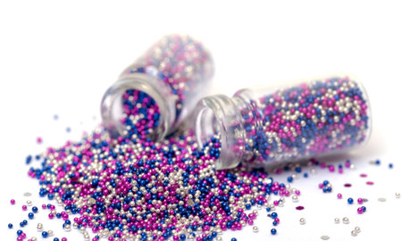 Small Glass Jars filled with Multicolored Balls of Bead, closeup