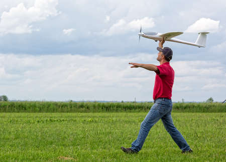 Man launches into the sky RC glider, blue sky backgroundの写真素材