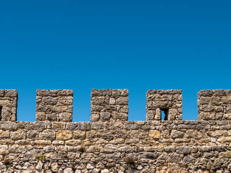 Ancient Stone Fortress Wall on Blue Sky Backgroundの写真素材